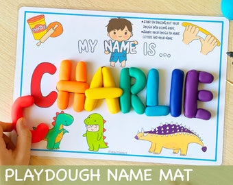 May include: A white playdough name mat with a cartoon boy and the words "My name is..."  The mat has a space for a child to form their name using playdough. The letters "CHARLIE" are formed with colorful playdough. There are three cartoon dinosaurs at the bottom of the mat.