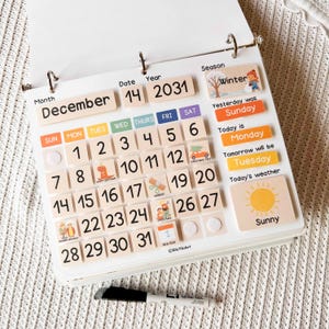 May include: Wooden educational calendar with the month of December, date 14, and year 2031. Includes day of the week, weather, and season indicators. Features a sunny weather icon and a winter season illustration. A black marker is at the bottom.