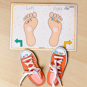 May include: A learning game for kids featuring two orange shoes with white laces and the words "Left" and "Right" on them. The shoes are placed on a white card with two orange feet with the words "Left" and "Right" on them. The card has a white background with orange polka dots.