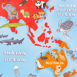 May include: A colorful illustration of a world map with animals from different continents. The map shows Asia, Australia, and the surrounding oceans. Animals include an elephant, a panda, a tiger, a crocodile, a shark, a turtle, a koala, a kangaroo, an emu, a cockatoo, and a kiwi.