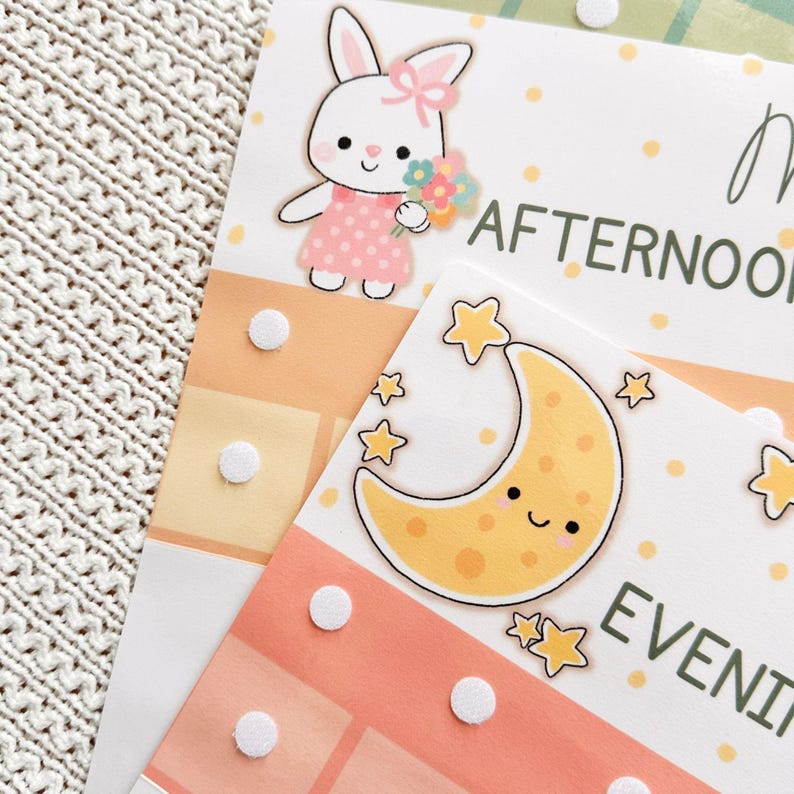 May include: Planner pages featuring a cartoon bunny with flowers and the word "AFTERNOON". A smiling crescent moon and stars are also shown with the word "EVENING". The pages have a peach and yellow colour scheme with white polka dots and white velcro dots.