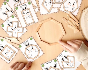 May include: A set of printable cards featuring different geometric shapes with cute bunny illustrations. Each card has the name of the shape and a dotted line outline. The cards are designed for use with popsicle sticks to create the shapes.