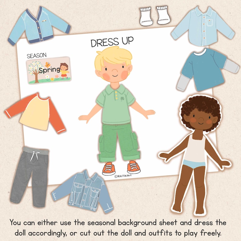 May include: A children's dress-up paper doll set with various clothing options, including shirts, pants, and jackets. The set includes two paper dolls, one with blonde hair and the other with dark hair. The text "DRESS UP" is visible.