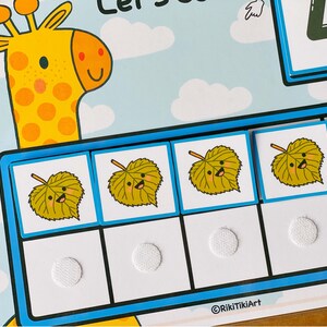May include: A blue and white learning game with a giraffe illustration and four yellow leaves with smiling faces. The game includes the text "Let's Count 4".