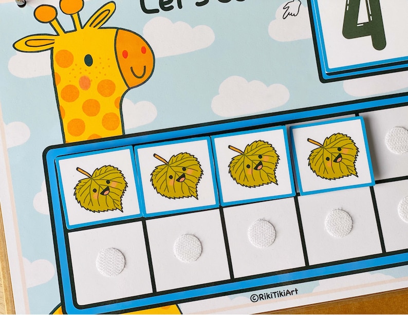 May include: A blue and white learning game with a giraffe illustration and four yellow leaves with smiling faces. The game includes the text "Let's Count 4".