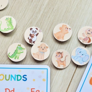 May include: A set of colorful, round, felt animal stickers with various animal illustrations. The stickers are designed for learning beginning sounds. The text on the card reads "Beginning Sounds".