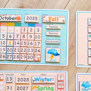 May include: A colorful wooden calendar with removable pieces for teaching days of the week, months, seasons, years, and weather. The calendar features a bright blue background with yellow stars and a picture of a storm cloud with lightning.