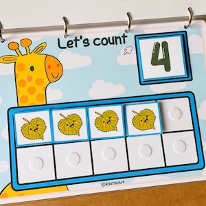 May include: A colorful educational counting activity featuring a cartoon giraffe and leaves. The activity includes a number card with the number "4" and six spaces to count the leaves. The text "Let's count" is written at the top of the page.