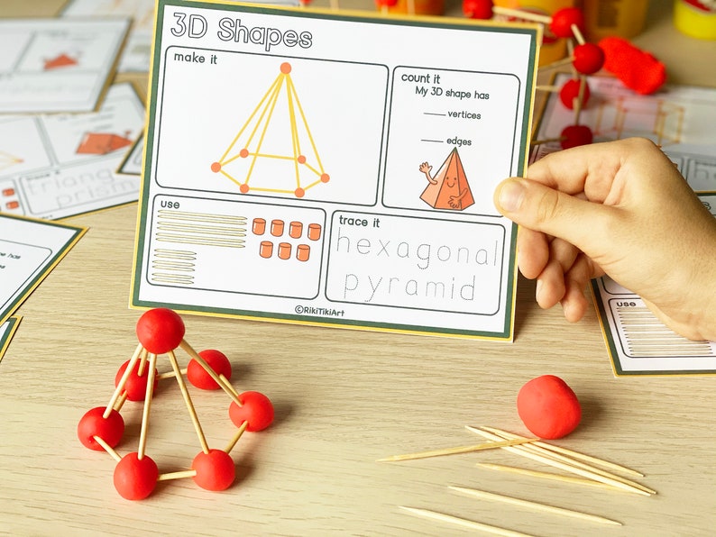 May include: A worksheet with instructions to make a hexagonal pyramid using toothpicks and playdough. The worksheet includes a diagram of the shape, a place to count the vertices and edges, and a space to trace the word "hexagonal pyramid".
