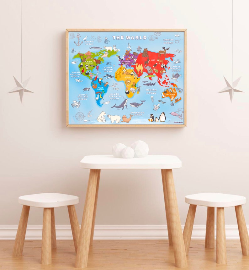 May include: A framed world map with a blue background and colorful continents. The map features animals from each continent, including a polar bear, a camel, a penguin, and a toucan. The map is titled "The World" and is hanging on a white wall above a white table and two white stools.