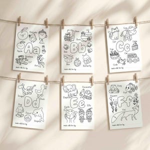 May include: Six white rectangular coloring pages featuring letters A through F with black line art illustrations of animals and objects. Each page includes the letter, corresponding words like Apple, Bear, Cat, Dragon, Elephant, and Fox, and a line for names.