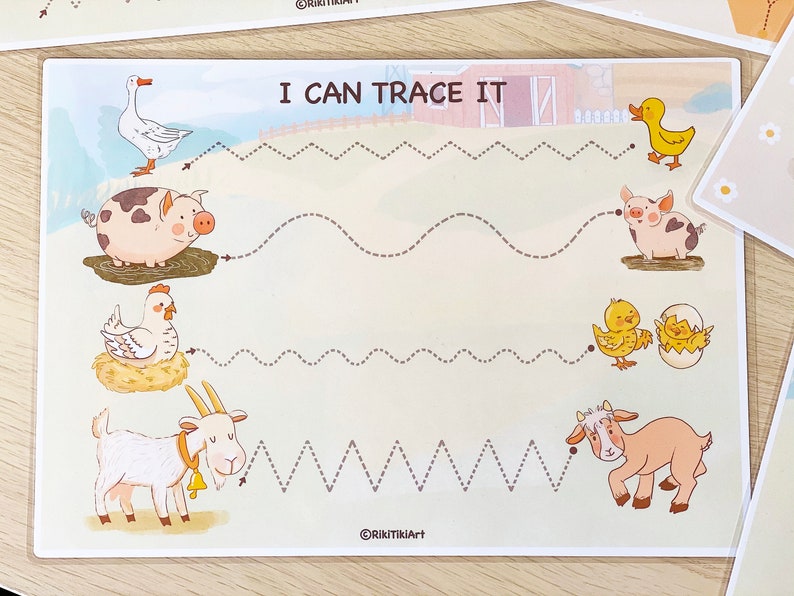 May include: A printable worksheet with the text "I Can Trace It" at the top. The worksheet features a variety of farm animals, including a goose, pig, chicken, goat, and ducklings. The animals are connected by dotted lines that children can trace.