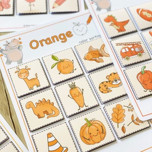 Puede incluir: Juego de clasificaci&oacute;n de colores naranja con im&aacute;genes de una jirafa, un dinosaurio, una zanahoria, una calabaza, un cono de tr&aacute;fico, un pez dorado, un tigre y una naranja. El juego incluye el texto "Naranja" y "clasificaci&oacute;n de colores".