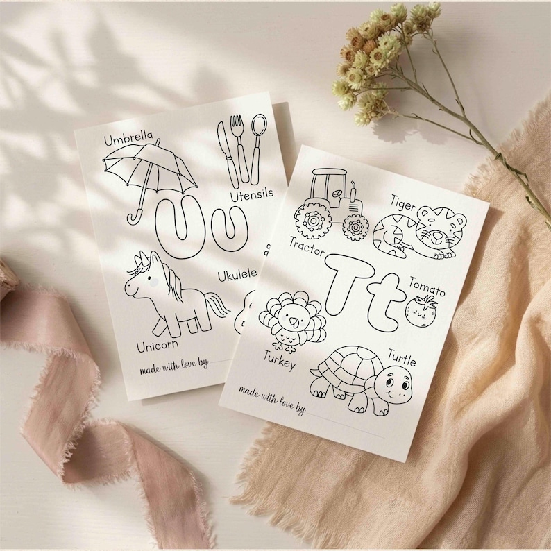 May include: Two white coloring pages featuring the letters U and T with black line art illustrations. The U page shows an umbrella, utensils, and a unicorn. The T page shows a tractor, tiger, tomato, turkey, and turtle. Both pages include the text made with love by.