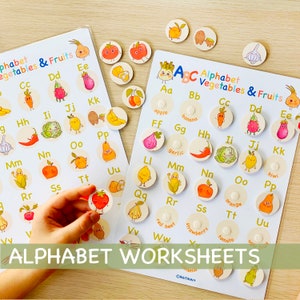 May include: Two alphabet learning charts with colorful illustrations of fruits and vegetables. The charts feature the letters of the alphabet with a corresponding image for each letter. The charts are designed for children to learn the alphabet and identify different fruits and vegetables.
