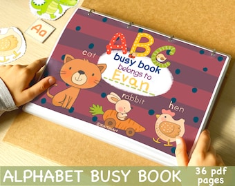 May include: A colorful alphabet busy book with a purple cover and a title that reads "ABC busy book belongs to Evan". The book features illustrations of a cat, rabbit, and hen.