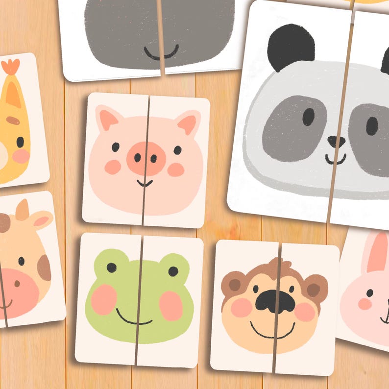 May include: A collection of animal-themed matching puzzles. Each puzzle features a split image of a different animal, including a pig, panda, frog, and monkey, with a smiling face. The puzzles are on a light wooden surface.