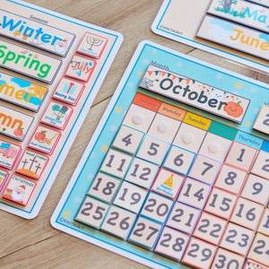 May include: A colorful wooden calendar with removable tiles for teaching months, days, seasons, and holidays. The calendar features a blue background with white clouds and stars. The tiles are made of wood and have various colors and designs.
