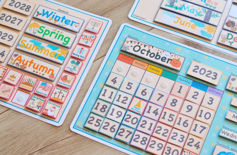 May include: A colorful wooden calendar with removable tiles for teaching months, days, seasons, and holidays. The calendar features a blue background with white clouds and stars. The tiles are made of wood and have various colors and designs.