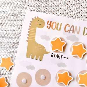 May include: A children's reward chart with a cartoon dinosaur illustration. The chart features orange star-shaped stickers and the text "YOU CAN DO". The word "START" is also visible.