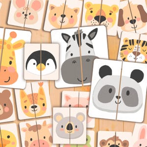 May include: A collection of square animal puzzle pieces with a variety of cute animal faces, including a zebra, panda, and penguin. The pieces are divided in half, ready to be matched. The background is a light wood grain.