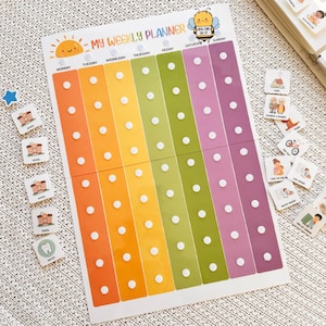 May include: A colorful weekly planner with the text "MY WEEKLY PLANNER" and a smiling sun illustration. The planner has columns for each day of the week, with white dots for attaching activity markers. Includes activity markers with illustrations.