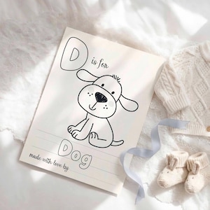 May include: A white rectangular card featuring a black line drawing of a puppy. The text reads D is for Dog and made with love by. The card includes dashed lines for writing practice, positioned next to a pair of small cream-colored knit baby booties.