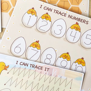 May include: A printable worksheet for kids to practice tracing numbers 1 through 10. Each number is inside a white egg with a yellow chick peeking out. The worksheet has a title that says "I Can Trace Numbers".