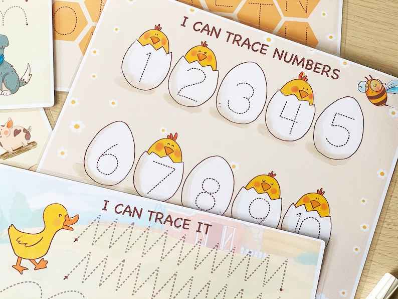 May include: A printable worksheet for kids to practice tracing numbers 1 through 10. Each number is inside a white egg with a yellow chick peeking out. The worksheet has a title that says "I Can Trace Numbers".