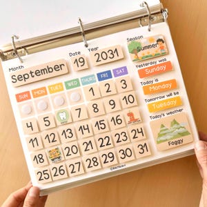 May include: A wooden educational calendar for children, featuring the month of September, date 19, and year 2031. Includes days of the week, numbers, and weather indicators. The calendar is open, showing the current date and season.