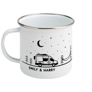 May include: White enamel mug with a black and white illustration of a camper van driving through a forest at night with a crescent moon and stars in the sky. The text "EMILY & HARRY" is printed below the van.