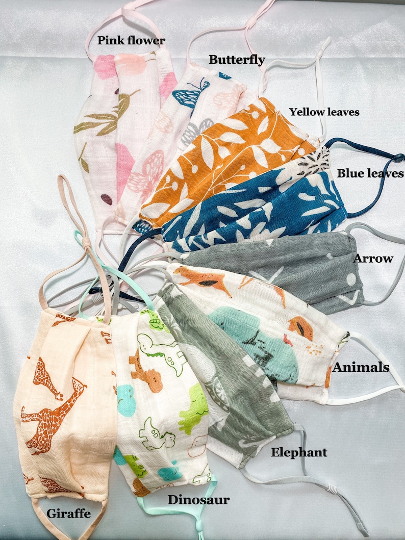 May include: Assortment of face masks with various patterns. Designs include pink flowers, butterflies, yellow and blue leaves, arrows, giraffes, dinosaurs, elephants, and other animals. Each mask has adjustable ear loops for a comfortable fit.