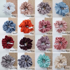 May include: A collection of 16 scrunchies in various colors, including white, champagne, taupe, sky blue, steel blue, rust, old rose, dusty pink, burgundy, red wine, mauve, dusty rose, light gray, metallic gray, mint, and ivory.