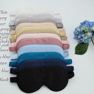 May include: A set of 13 silk sleep masks in various colours, including white, ivory, silver, dark grey, champagne, gold, khaki, light pink, mauve, sky blue, Tibetan, navy blue, and black.