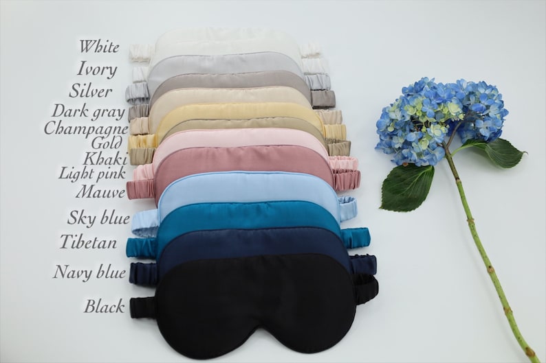 May include: A set of 13 silk sleep masks in various colours, including white, ivory, silver, dark grey, champagne, gold, khaki, light pink, mauve, sky blue, Tibetan, navy blue, and black.