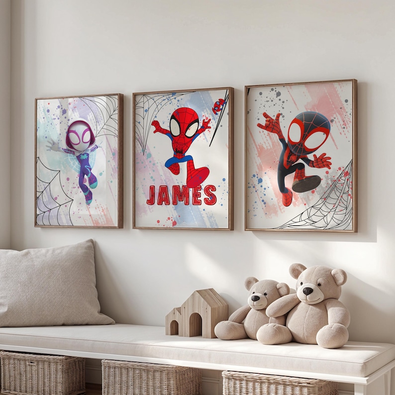May include: Three framed prints featuring cartoon Spider-Man characters. The center print has the name "JAMES" written in red letters. The prints are displayed on a white wall above a wooden bench.