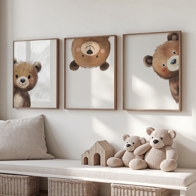May include: Three framed illustrations of brown bears with white backgrounds. The bears are depicted in different poses, with one looking directly at the viewer, one looking over its shoulder, and one upside down. The frames are a light brown wood.