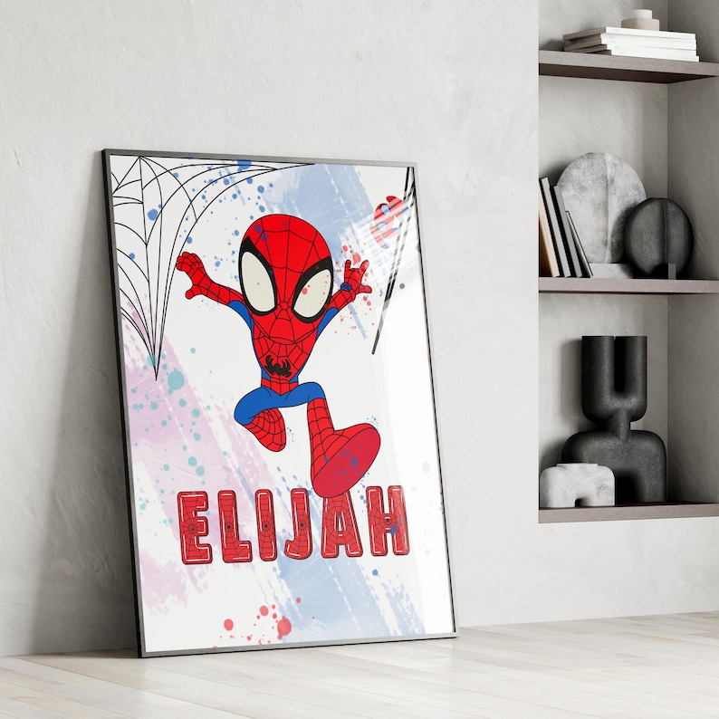 May include: A colorful printable art print featuring a cartoon Spiderman character in a red and blue suit, swinging through a web with a white, blue, and pink watercolor background. The name "ELIJAH" is written in red letters at the bottom of the print.