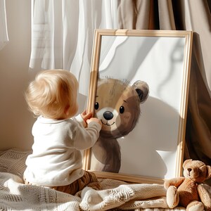 May include: A framed illustration of a brown bear with a white background. The bear is looking to the right and has a friendly expression. A child is looking at the picture.