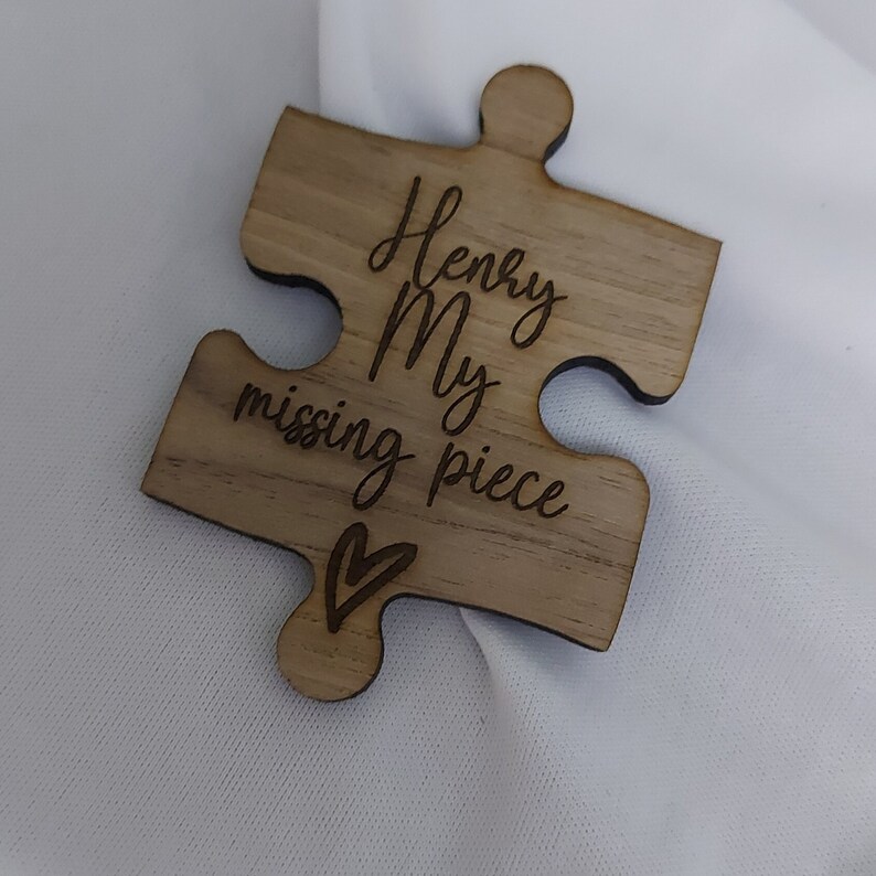 May include: A wooden puzzle piece with the text "Henry My missing piece" and a small heart engraved on it.