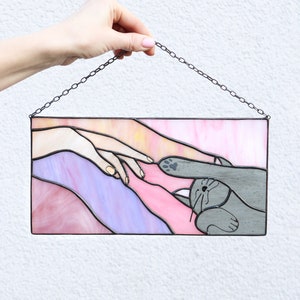 Suncatcher Cat reaching for a human hand with its paw Stained glass window panel Hanging home decor Glass wall art Gift for cat lovers Pink and purple