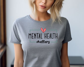 May include: Gray t-shirt with a black rectangle and the text "MENTAL HEALTH matters" inside. A pink heart is above the text.