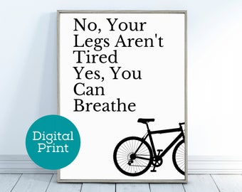 May include: Black and white printable poster with the text "No, Your Legs Aren't Tired Yes, You Can Breathe" and a silhouette of a bicycle.