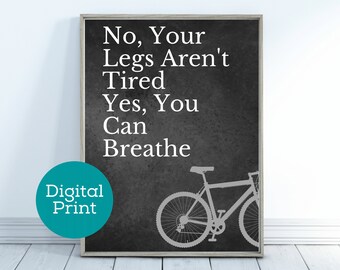 May include: A black and white digital print with the text "No, Your Legs Aren't Tired Yes, You Can Breathe" and a silhouette of a bicycle.