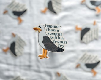 May include: A sticker featuring a cartoon seagull with the text "happier than a seagull with a french fry".