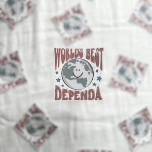 May include: A sticker with a brown background and white text that says "World's Best Dependa" with a cartoon earth with a smiley face in the center. The earth is blue and gray with white stars around it.