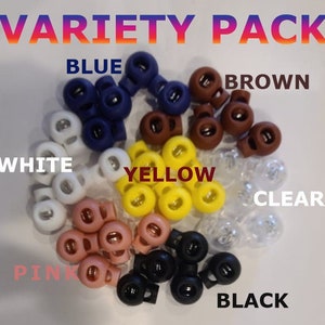 May include: Variety pack of plastic toggle stoppers in blue, brown, white, yellow, clear, pink, and black.
