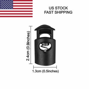 May include: Black plastic toggle buckle with a spring mechanism. The buckle measures 2.4 inches in height and 0.5 inches in width.