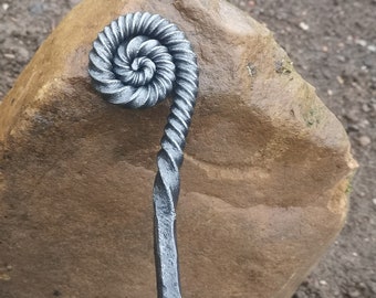 Ammonite style fire poker handcrafted in a blacksmiths forge
