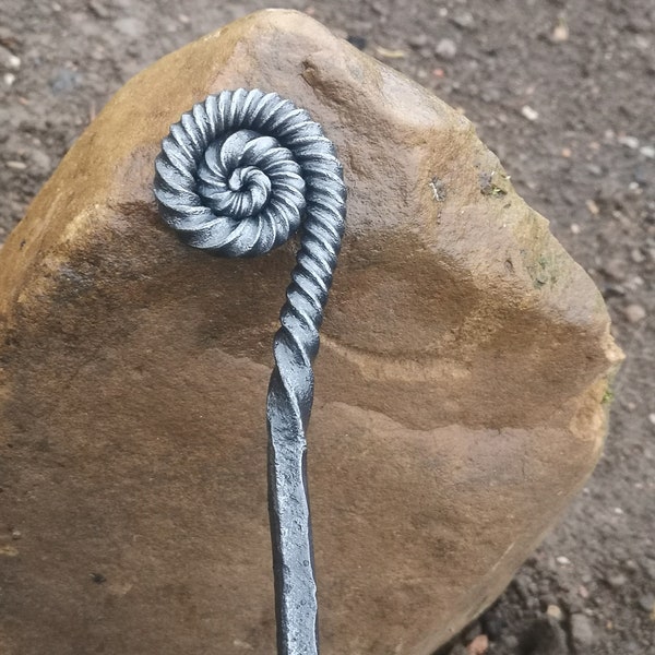 Ammonite style fire poker handcrafted in a blacksmiths forge